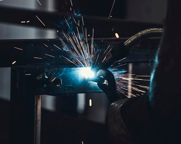 person welds metal