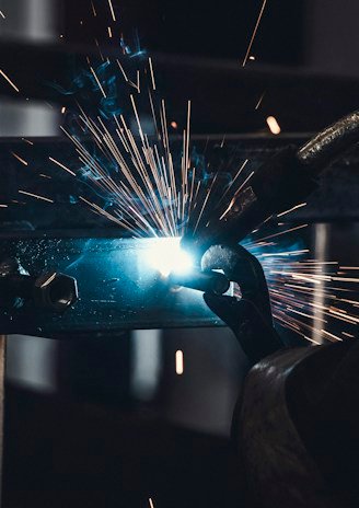 person welds metal